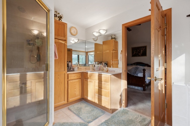 bathroom with walk in shower, tile patterned flooring, and vanity