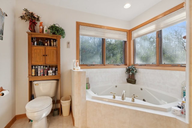 bathroom featuring toilet, tiled bath, and tile patterned floors