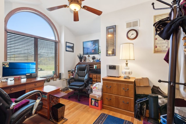 office area with a wealth of natural light, ceiling fan, light hardwood / wood-style flooring, and vaulted ceiling