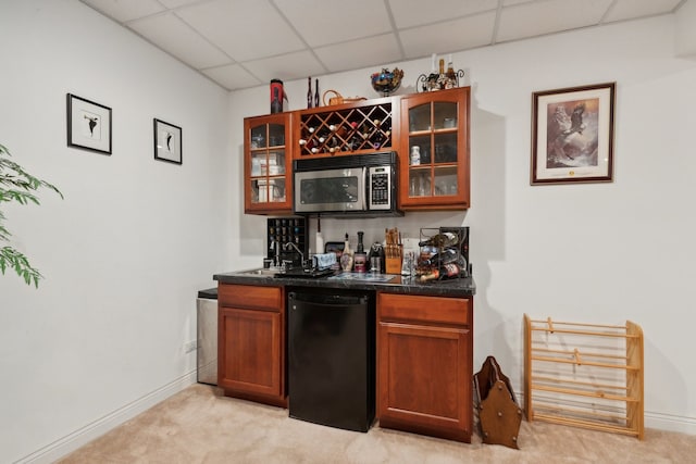 bar featuring sink, a paneled ceiling, light carpet, and dishwasher