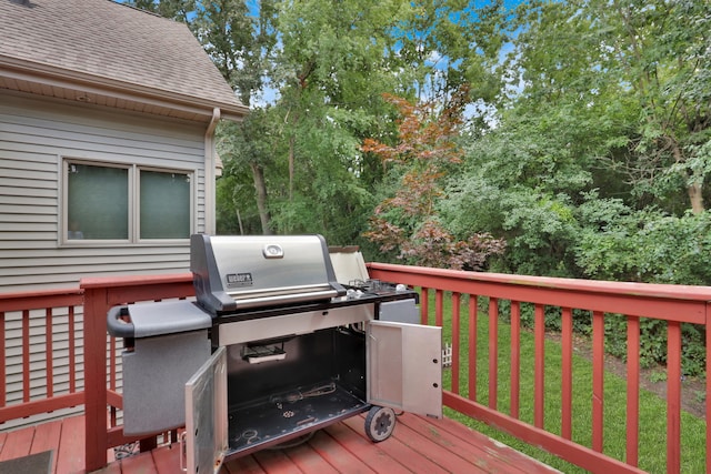 wooden terrace with grilling area and a yard