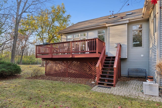 back of house with a lawn and a deck