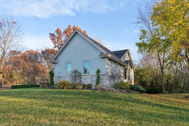 view of side of property with a lawn