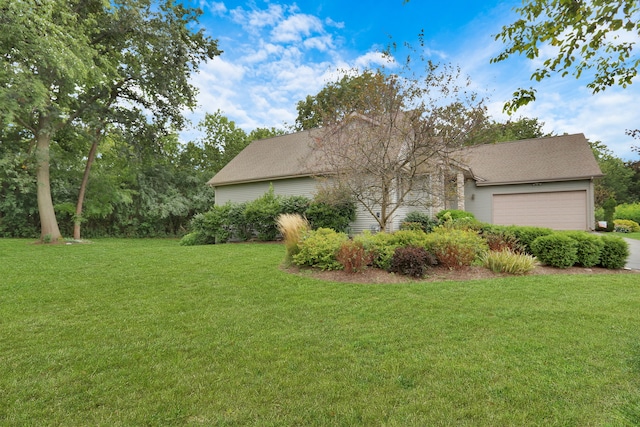 view of home's exterior featuring a garage and a lawn