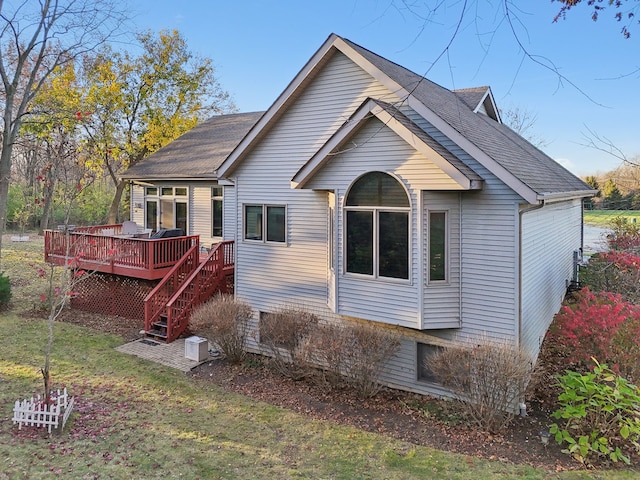 back of property with a wooden deck