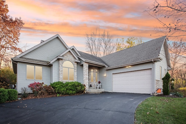 view of front of home with a garage and central AC