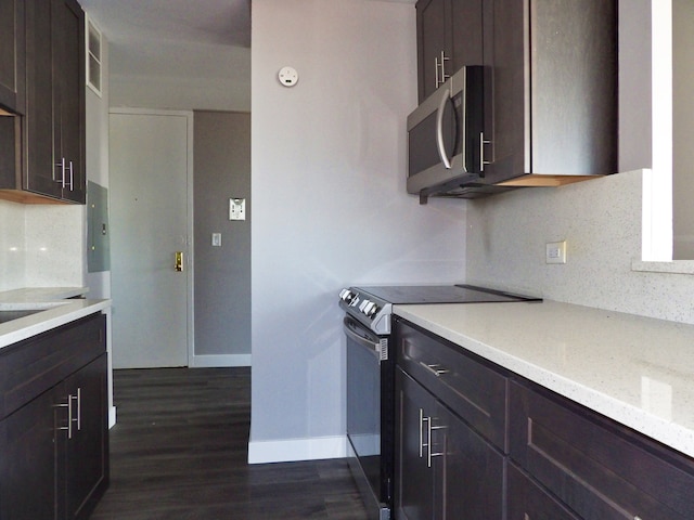 kitchen with dark brown cabinetry, dark hardwood / wood-style floors, backsplash, electric panel, and black / electric stove