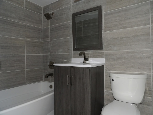 full bathroom featuring tile walls, vanity, shower / tub combination, and toilet