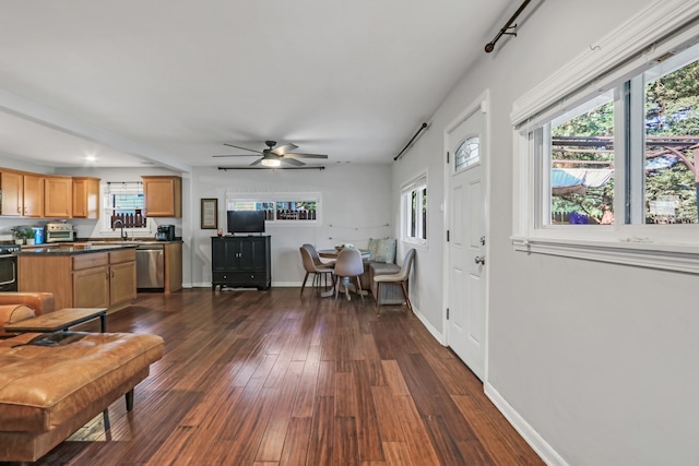 interior space featuring dark wood-type flooring, sink, and ceiling fan