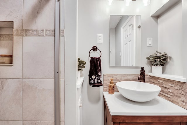 bathroom featuring vanity and decorative backsplash