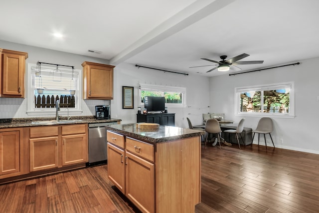 kitchen featuring dark hardwood / wood-style flooring, a center island, stainless steel dishwasher, sink, and ceiling fan