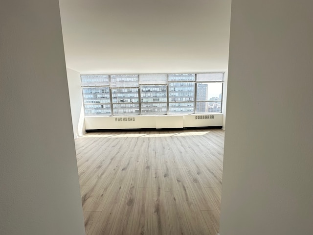 spare room with light hardwood / wood-style flooring