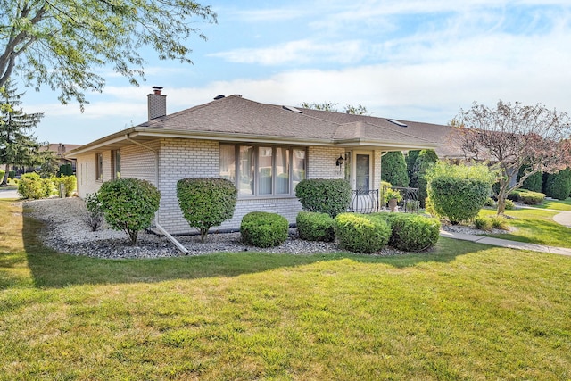 ranch-style home with a front lawn