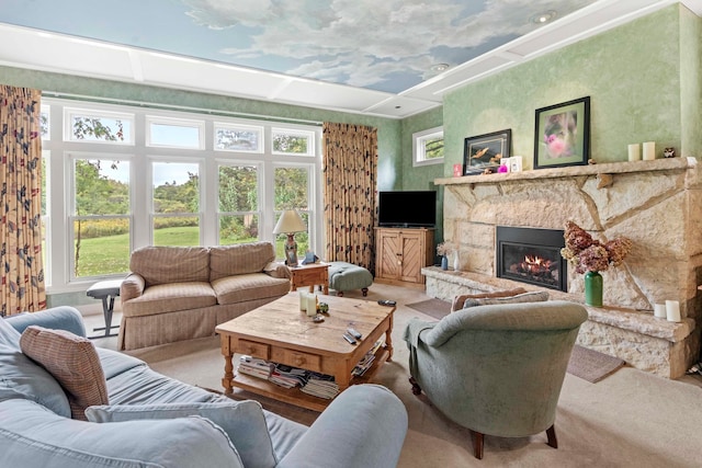 living room with a stone fireplace and carpet