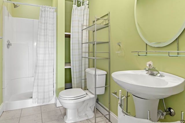 bathroom with toilet, walk in shower, and tile patterned floors