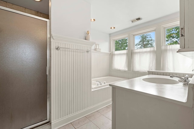 bathroom featuring vanity, plus walk in shower, and tile patterned floors