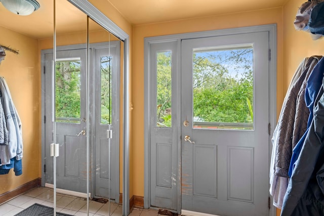 entryway with light tile patterned flooring and plenty of natural light