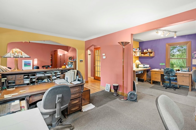 home office with crown molding and light colored carpet