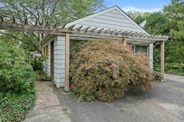 view of home's exterior featuring a pergola