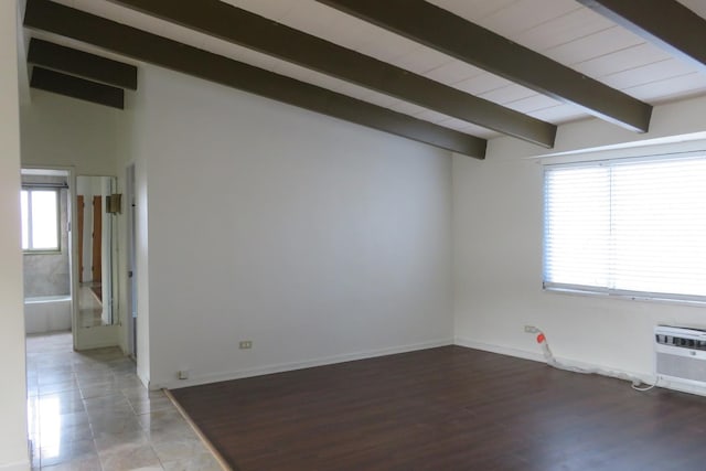 unfurnished room with a wall mounted air conditioner and lofted ceiling with beams