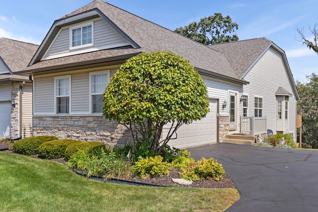 view of front of home with a front yard and a garage