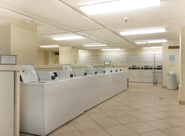 laundry area with light tile patterned floors and separate washer and dryer