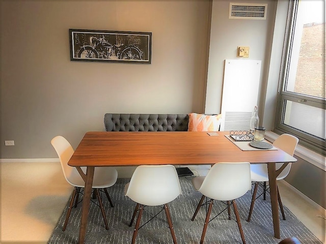 dining space featuring dark colored carpet