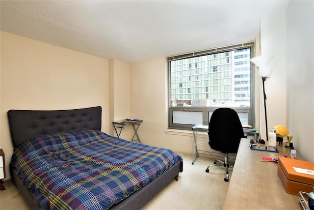 bedroom featuring a textured ceiling and carpet