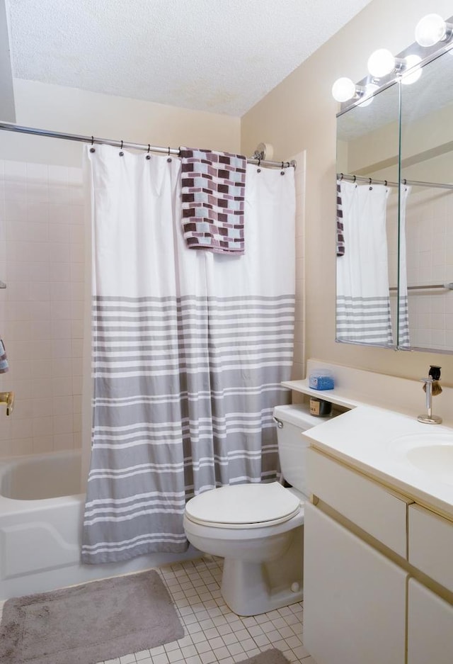 full bathroom featuring tile patterned flooring, toilet, shower / bath combination with curtain, vanity, and a textured ceiling