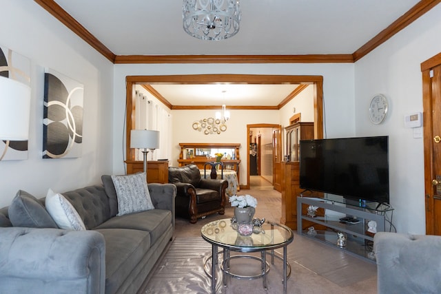 living room with ornamental molding, a chandelier, and carpet floors