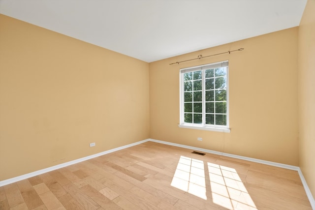 unfurnished room with light hardwood / wood-style flooring