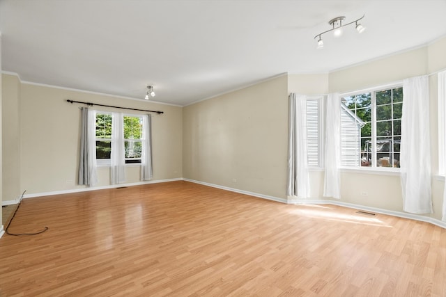 unfurnished room featuring light wood-type flooring and ornamental molding