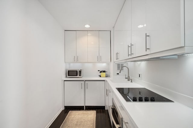 kitchen with white cabinets, stainless steel appliances, dark hardwood / wood-style flooring, and sink