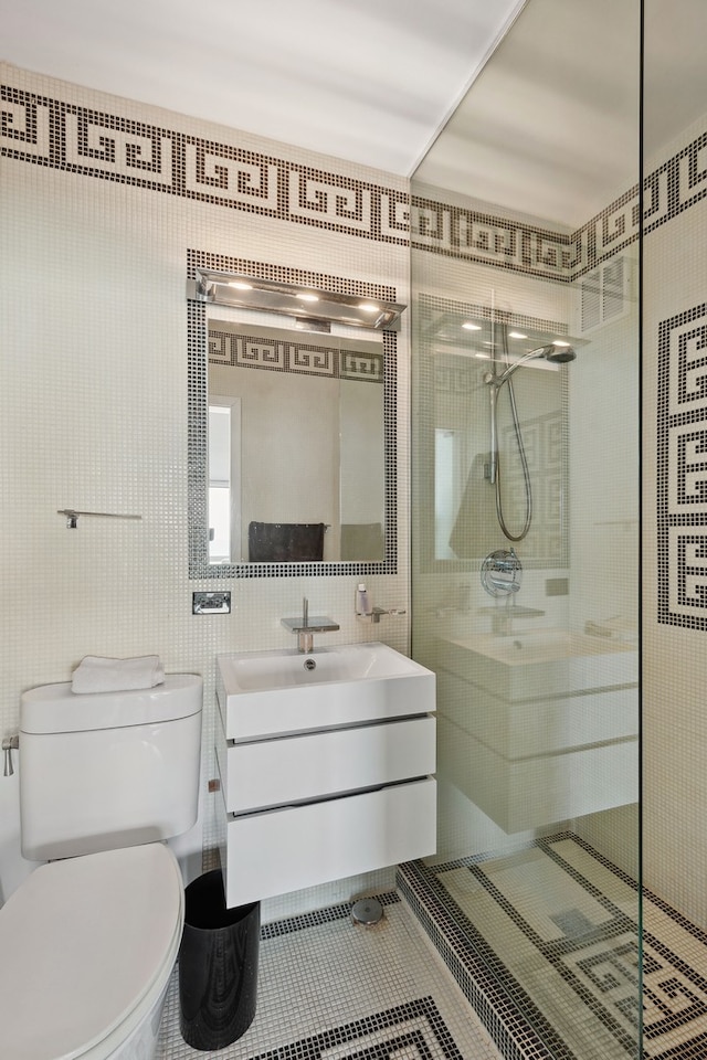 bathroom featuring vanity, toilet, a shower, and tile patterned flooring