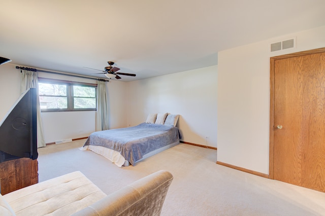 bedroom featuring ceiling fan and light colored carpet