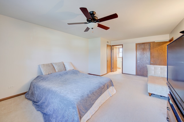 carpeted bedroom with connected bathroom and ceiling fan