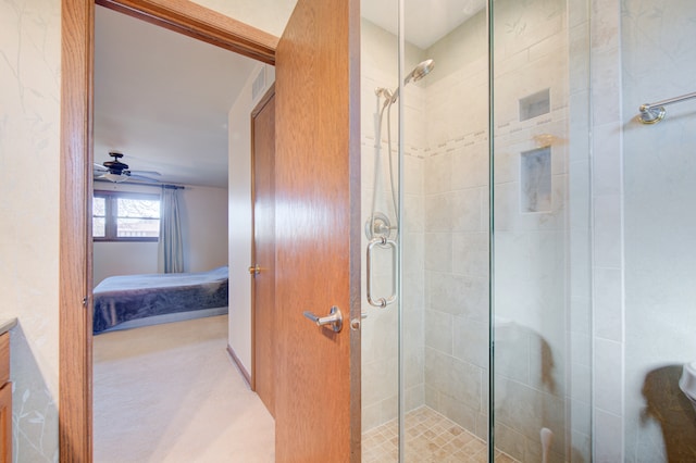 bathroom with ceiling fan, vanity, and a shower with door