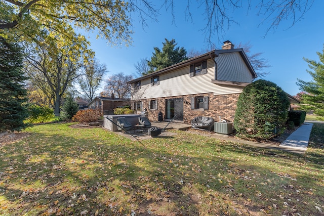 rear view of house featuring a lawn, a patio area, and central AC