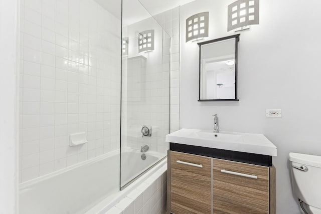 full bathroom with toilet, tiled shower / bath combo, and vanity