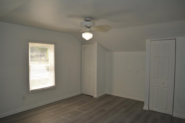 additional living space with vaulted ceiling, dark hardwood / wood-style flooring, and ceiling fan