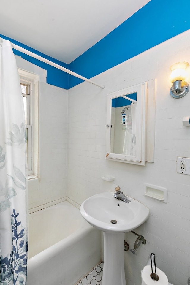 bathroom featuring tile walls, shower / tub combo, and tile patterned floors