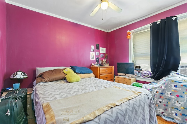 bedroom with crown molding, wood-type flooring, and ceiling fan