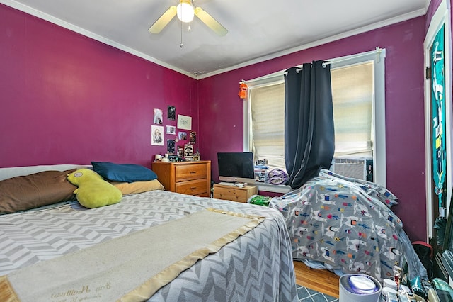 bedroom featuring ceiling fan, hardwood / wood-style flooring, and ornamental molding