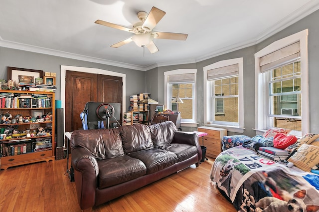 living room with ceiling fan, light hardwood / wood-style floors, and ornamental molding