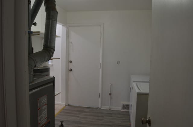 clothes washing area featuring separate washer and dryer and dark hardwood / wood-style flooring