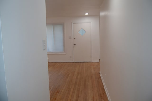 doorway to outside with light wood-type flooring