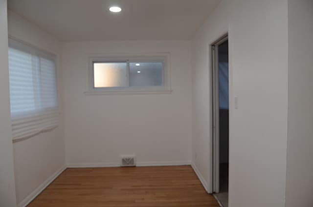 spare room with hardwood / wood-style floors