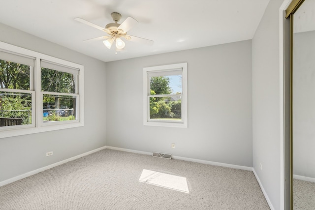 unfurnished room featuring ceiling fan and carpet floors