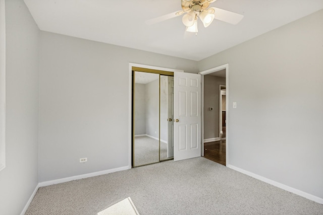 unfurnished bedroom with a closet, carpet, and ceiling fan