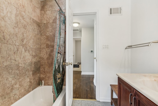 bathroom featuring vanity, shower / bathtub combination with curtain, and wood-type flooring